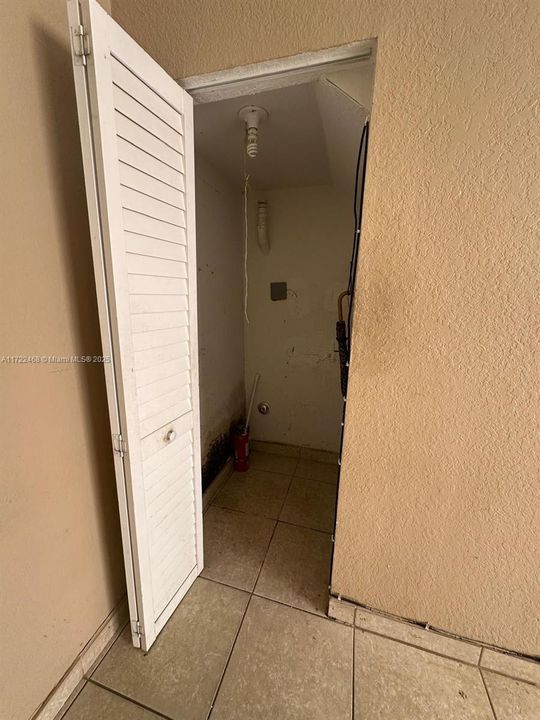 Laundry closet with hookups.