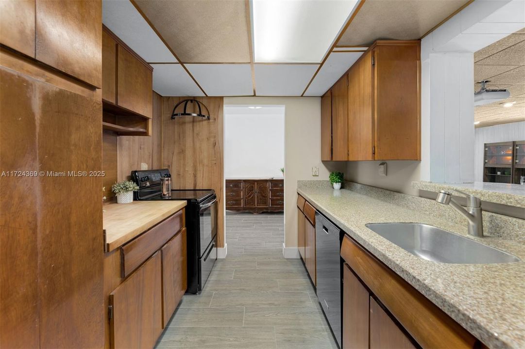 Original wood cabinetry with butcher block and granite countertops, drop ceiling can be raised