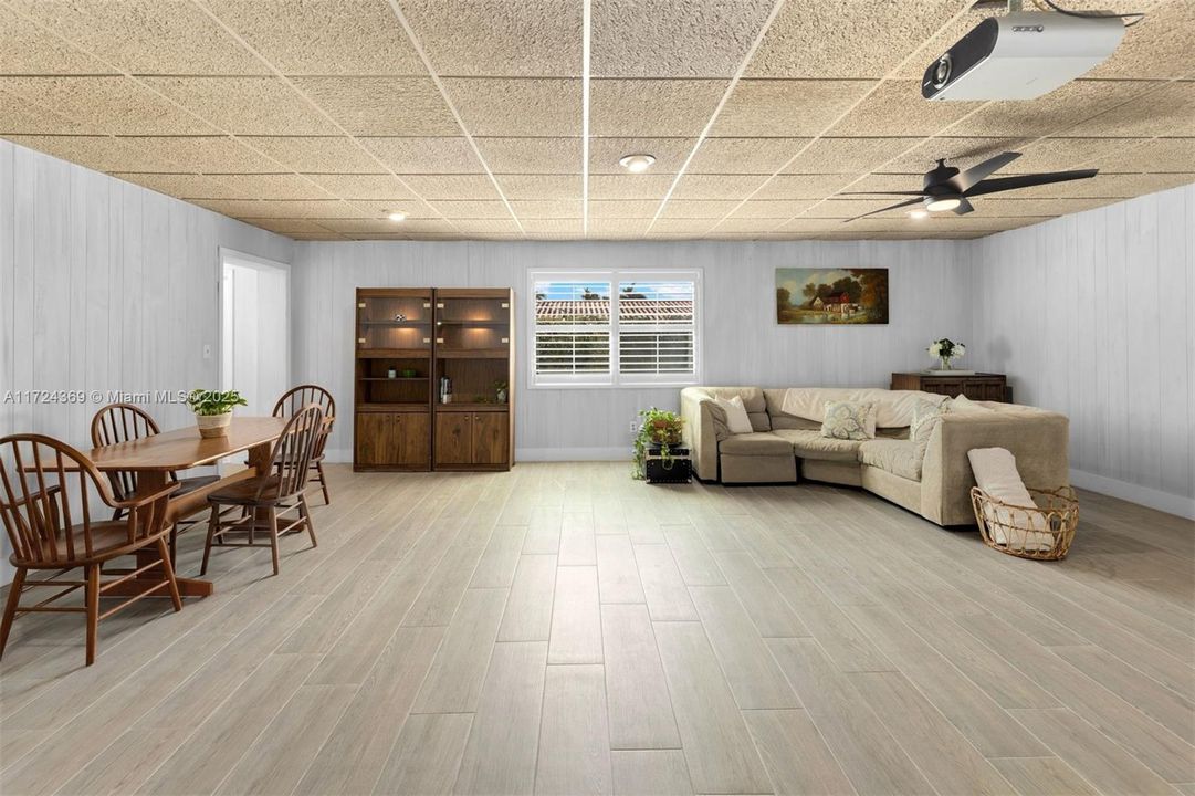 Huge family room with acoustic ceiling which can be raised, new porcelain flooring, plantation window treatments