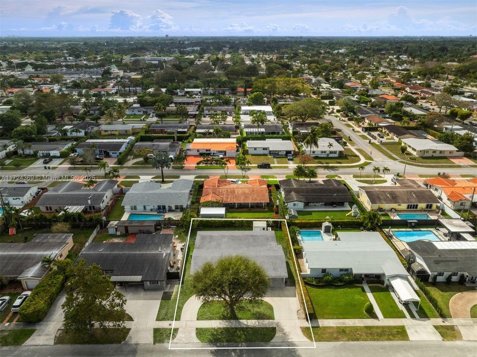 Concrete circular driveway on lovely tree-lined street with sidewalks close to schools