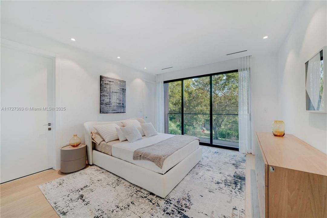 This bedroom has it's own walk-in closet plus full bathroom and Juliette balcony