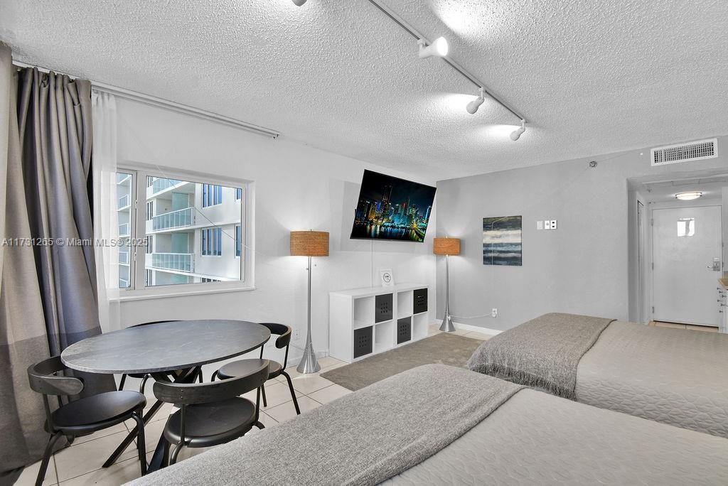 Comfortable and stylish bedroom layout with balcony access and ocean breeze views—ideal for a beachfront getaway.