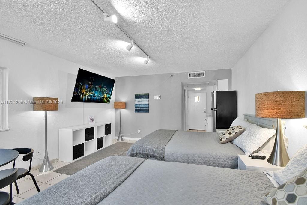 Ocean-view bedroom with modern décor and easy access to living areas—turnkey investment property.