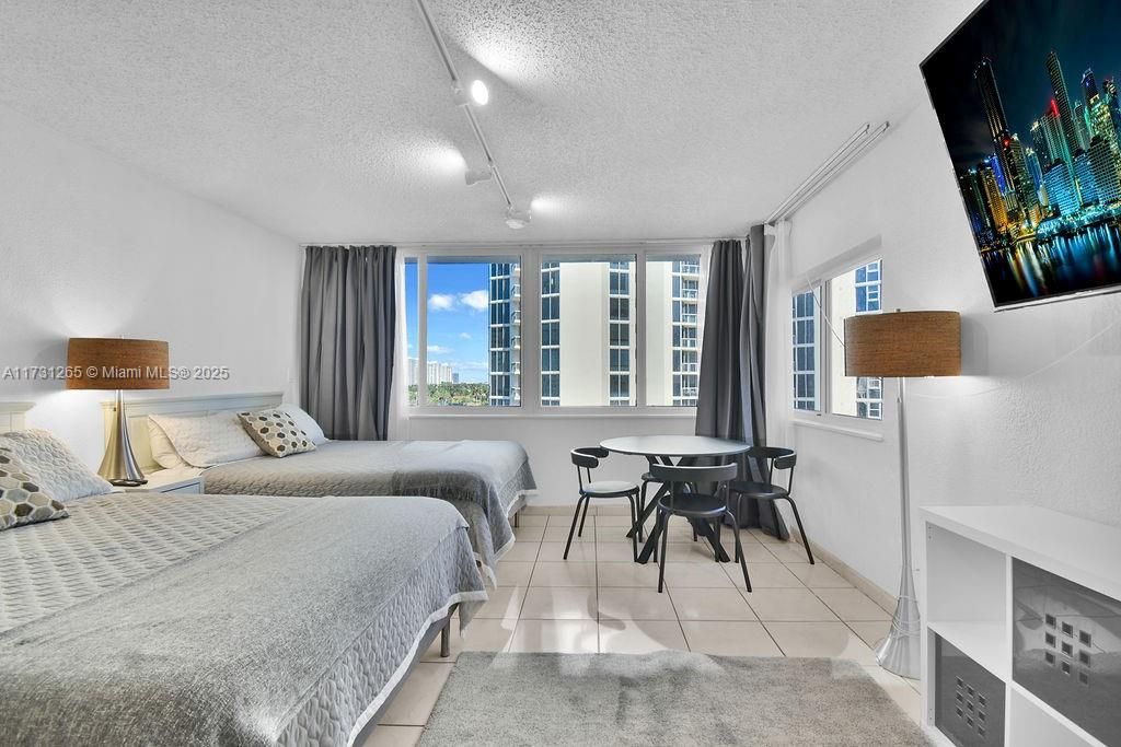 Comfortable and stylish bedroom layout with balcony access and ocean breeze views—ideal for a beachfront getaway.