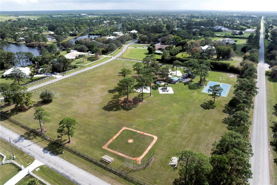 Soocer field to the left, playground back center and basketball court to the right. Baseball/softball front center.