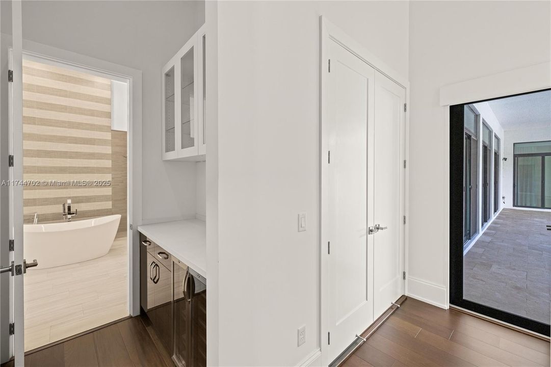 Entrace to primary bathroom with private bar area