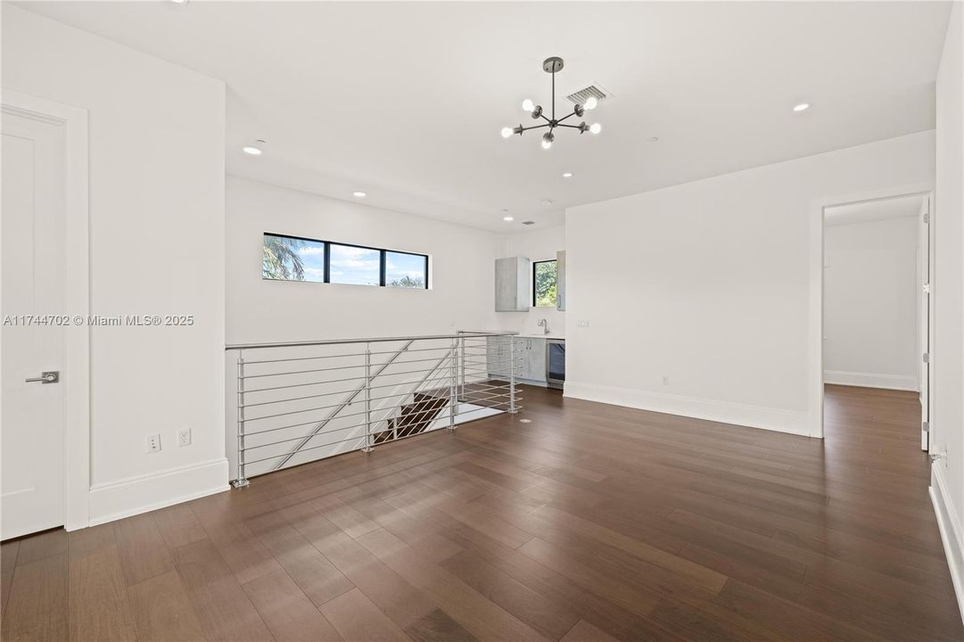 Second level landing with a full wet-bar and 3 full bedrooms and 3 full bathrooms.