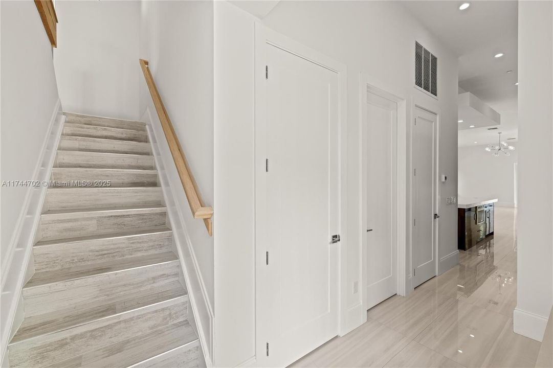 Rear staircase behind kitchen to Guest room #2