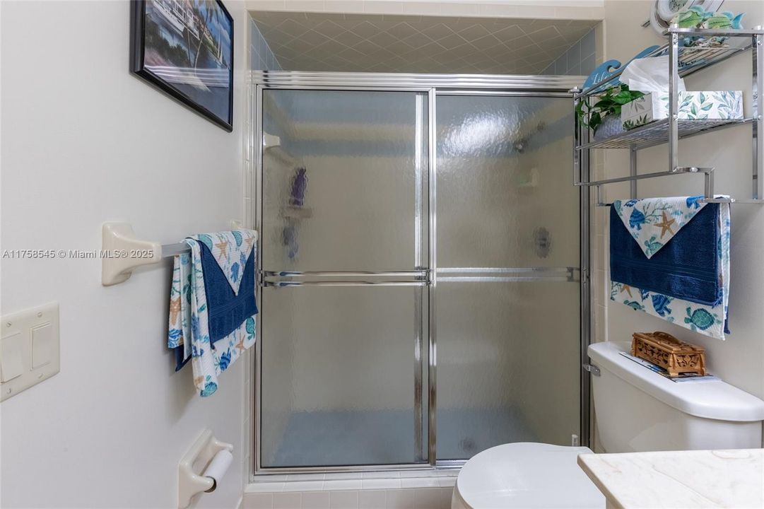 Guest bathroom in hallway with a shower