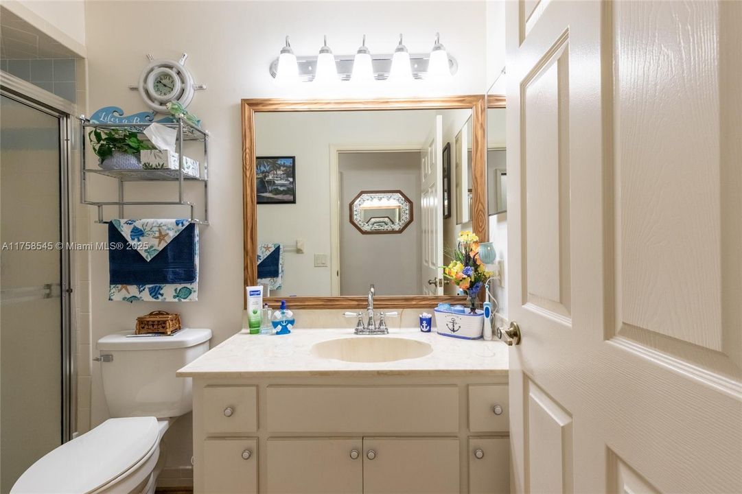 Guest bathroom in hallway with a shower