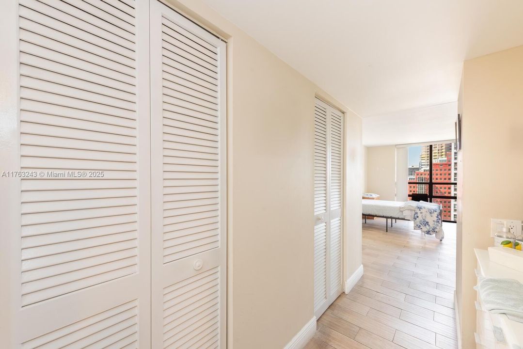 In primary bedroom, hallway to large walk in closet en route to primary bathroom.