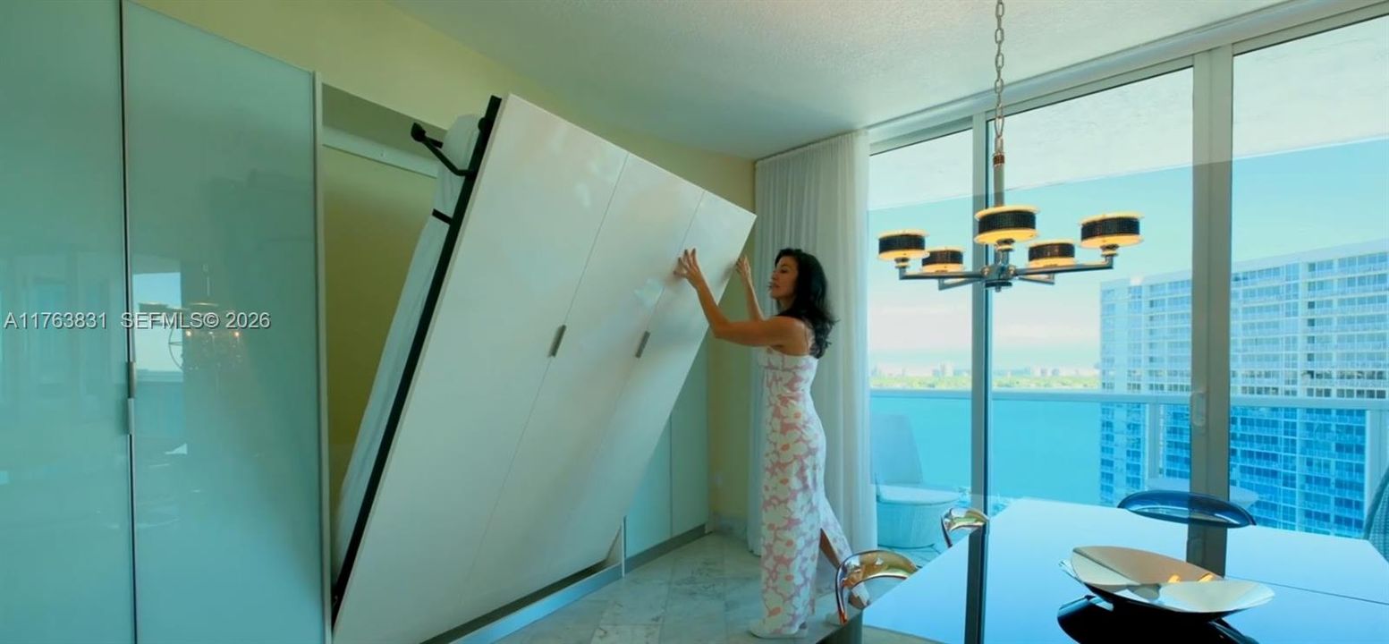 open-concept guest bedroom designed to maximize light and water views—perfect as a bedroom, office, or flex space. Dining table can be remove to put back the original space for the second guest bedroom