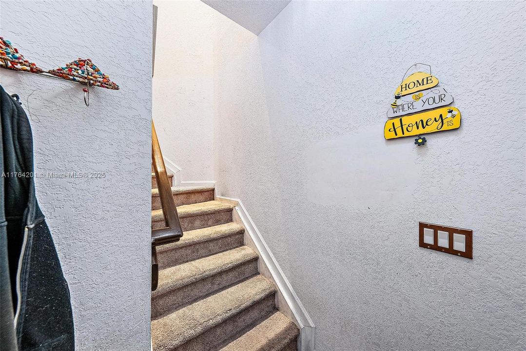 Enter from your attached 1 car garage or from outside door to your private staircase up to you living areas.