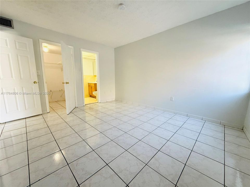 Primary Bedroom with Walk-In Closet and Half Bathroom
