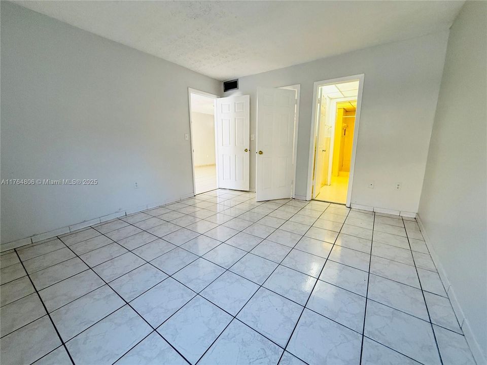Primary Bedroom with Walk-In Closet and Half Bathroom