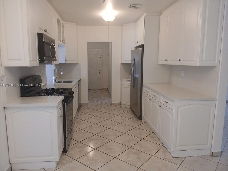 Laundry room next to kitchen