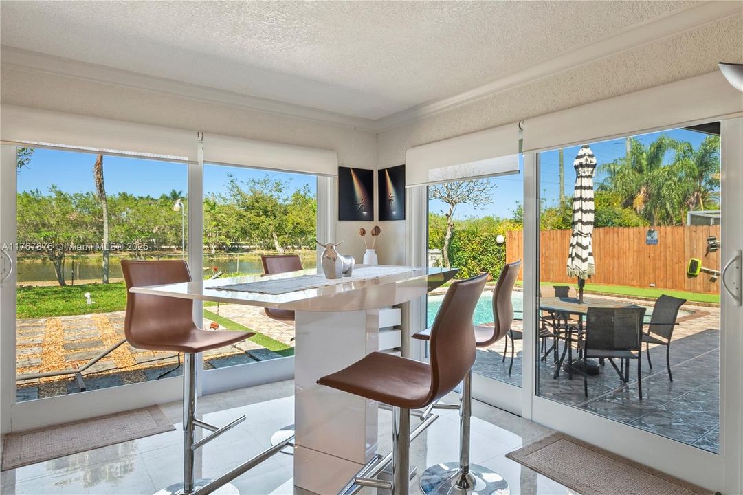 Sun room overlooking pool and lake