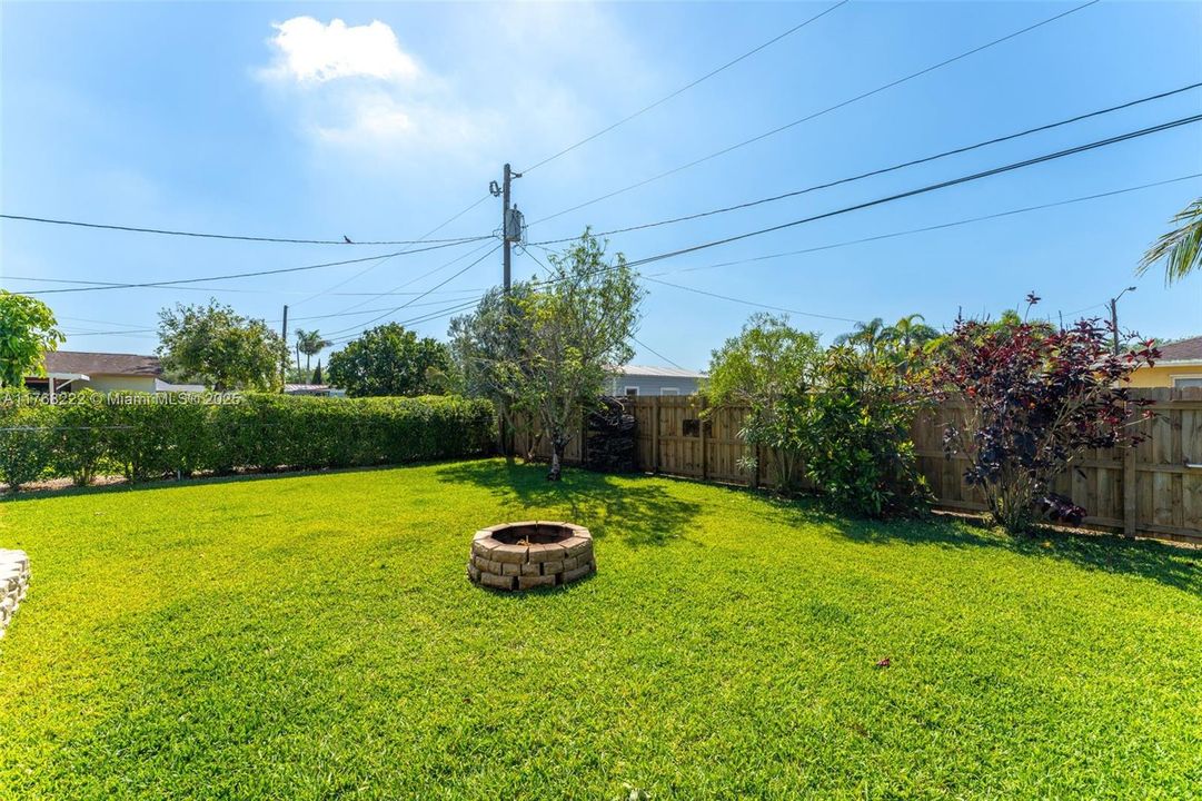 GRAND BACK YARD WITH FIRE PIT.