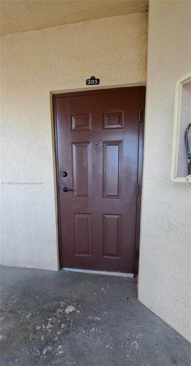 The lock box is in the railing in front of the door
