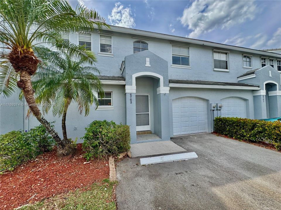 Townhome has a 1-car garage and 2 parking spots in front.