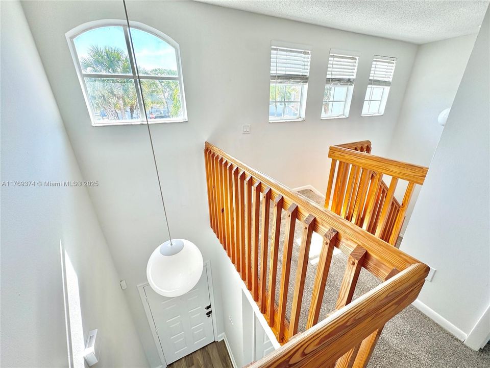 The front entry shows off vaulted ceilings with plenty of natural lighting.