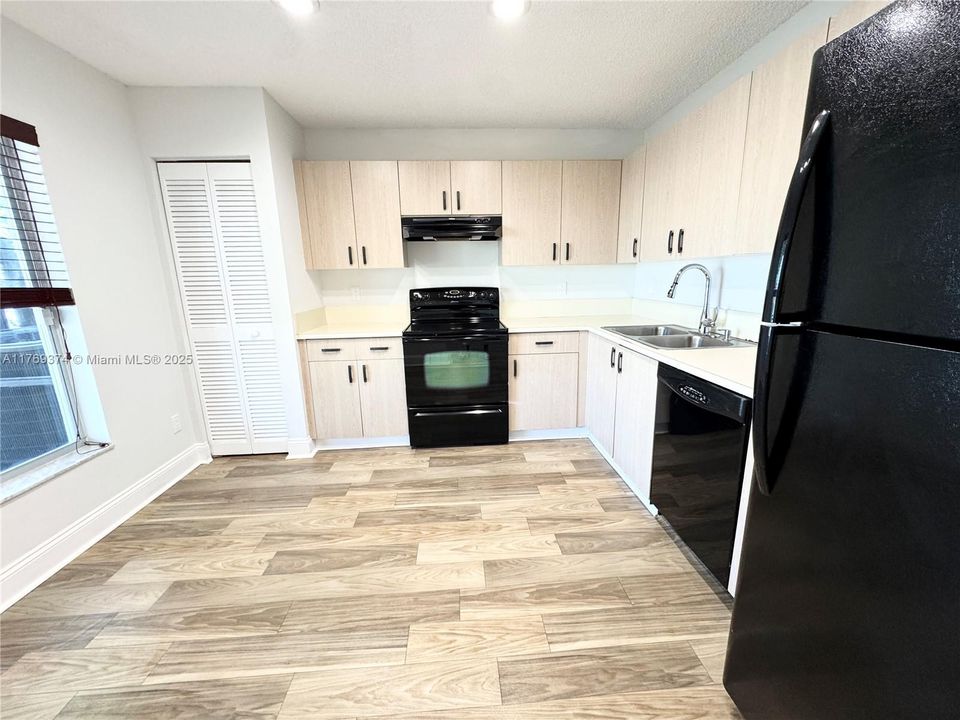 Large kitchen with plenty of storage space and a lake view from the window.