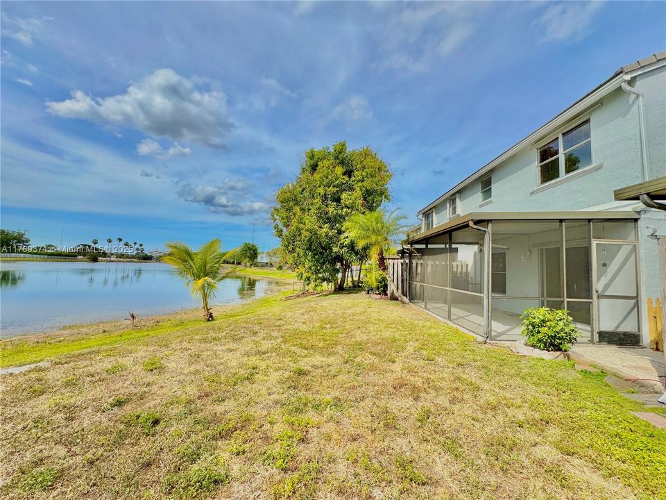 Stunning lakefront yard with screened in patio.