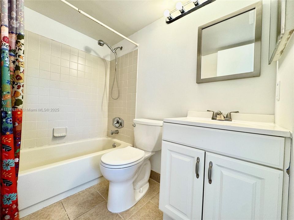 Upstairs hall bathroom has a tub-shower combo.