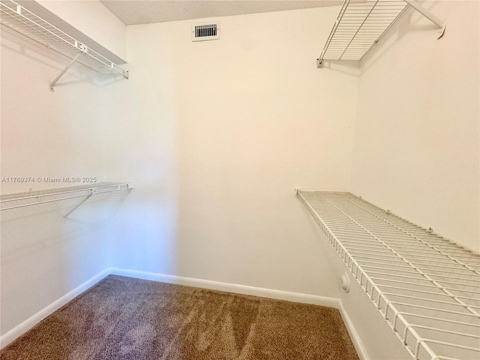 Primary bedroom with walk-in closet with entry to attic.
