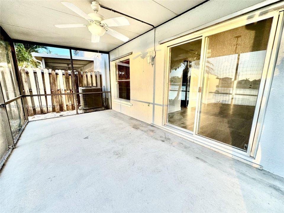 Sliding glass door leads to the screened in patio with lake view.