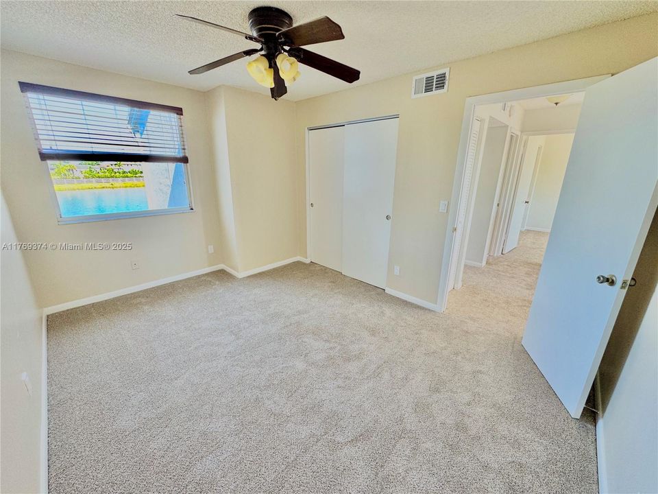 2nd bedroom has 2 closets for extra storage space with a lake view.