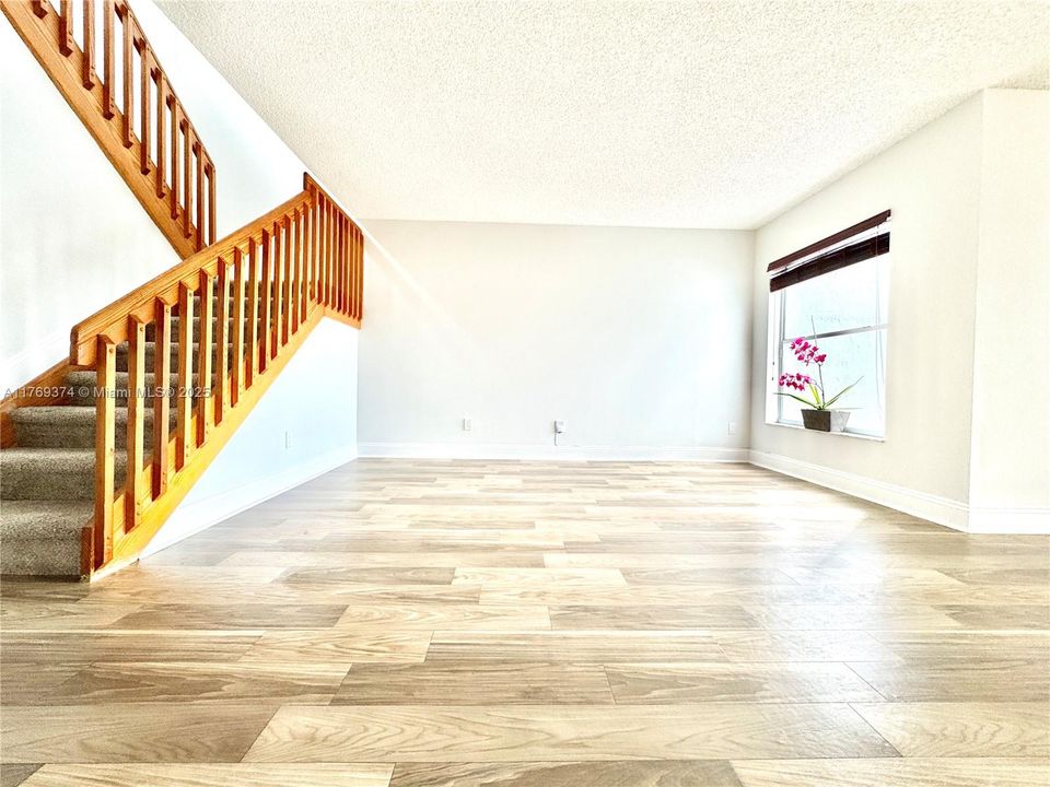 Stairs winding up to the 2nd floor in the living room.
