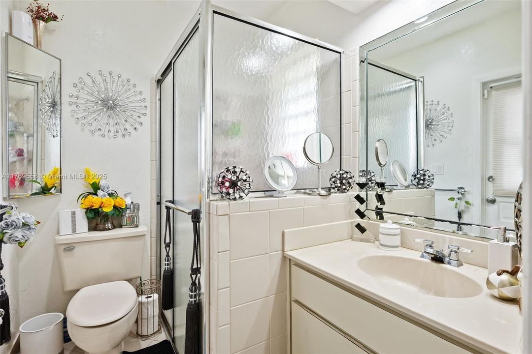 Bathroom attached adjacent to laundry area