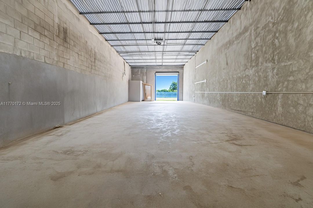 One roll up and one pedestria door.  16' ceilings.