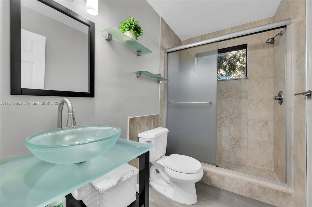 Guest bathroom has a stand up shower