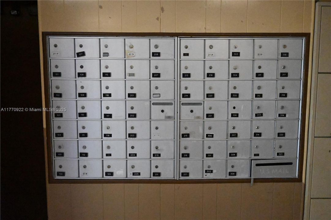 Realtors lock-box next to mailboxes.