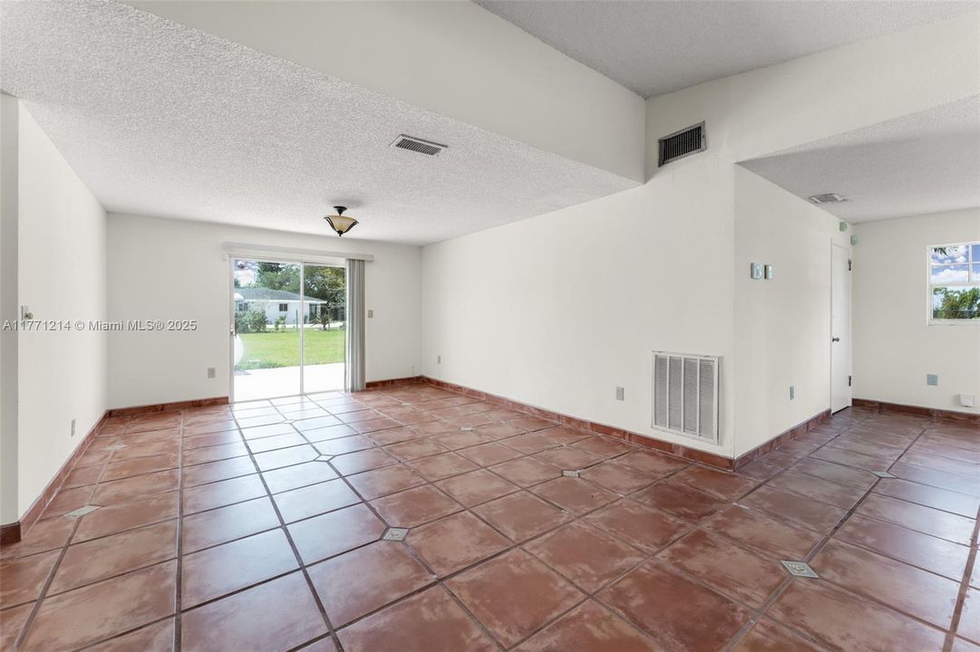 OPEN LIVING ROOM / FAMILY ROOM WITH SLIDING DOORS TO THE BACK OF THE PROPERTY. OFFICE/ DEN IS ADJACENT IN PHOTO'S.