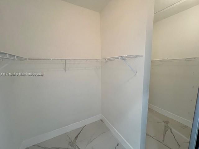 Walk-in his and hers closet in master bed