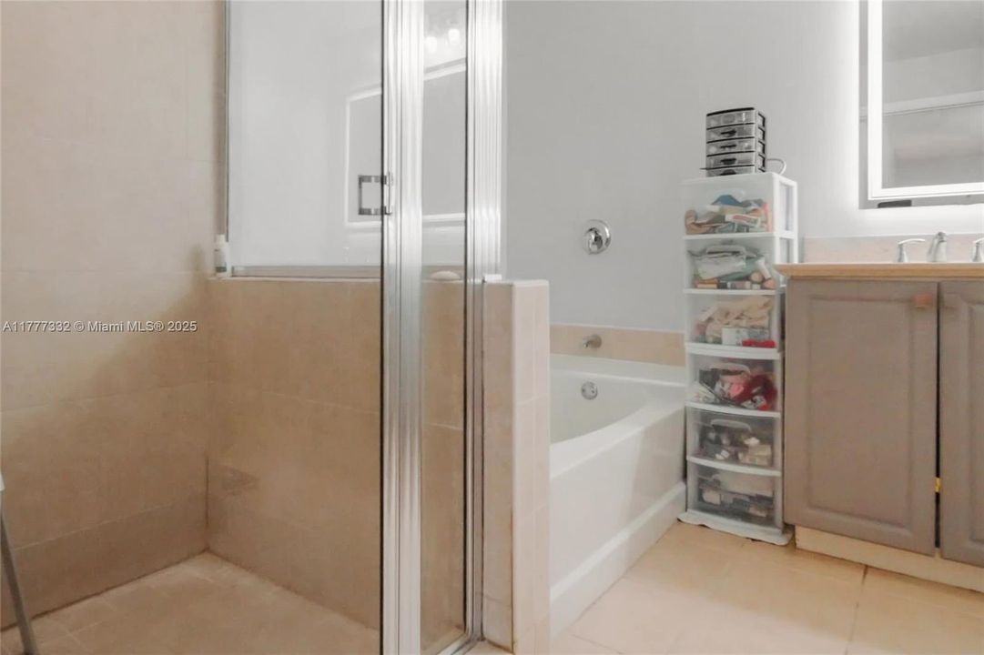 with his and her vanities and shower + bathtub