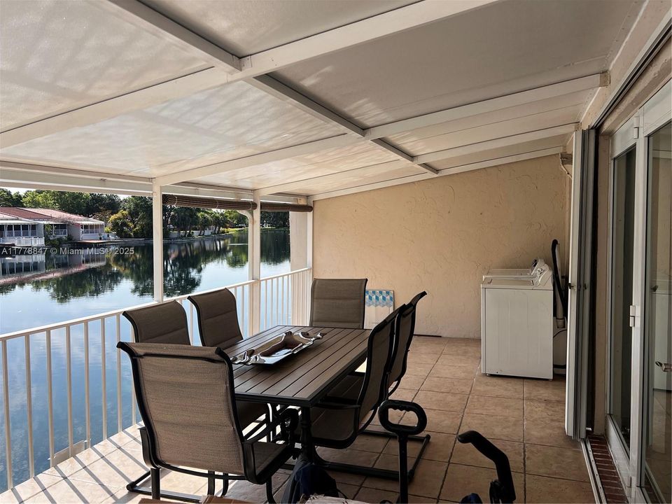 Rear covered deck with peaceful view to Lake Martha.