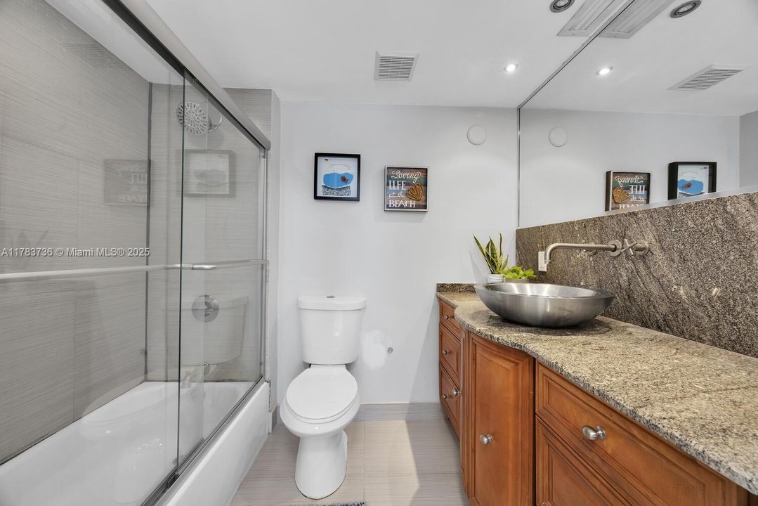 Main bathroom. Tub and a shower. Beautiful stone counter.