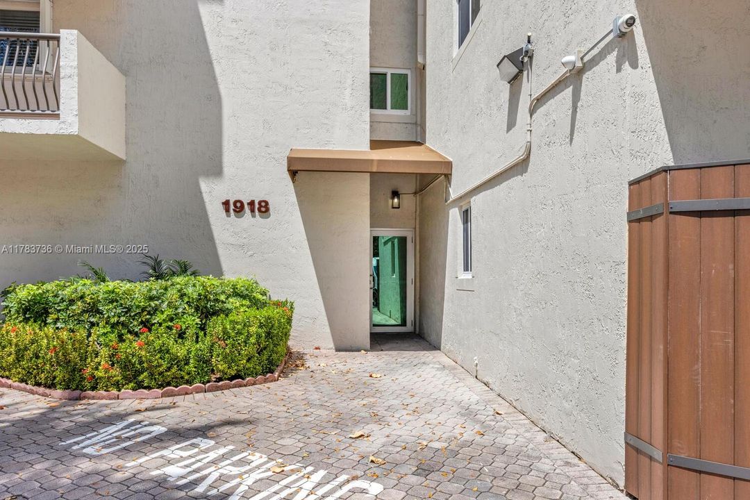 Pedestrian entrance. A 26 unit building with a pool. Gated.