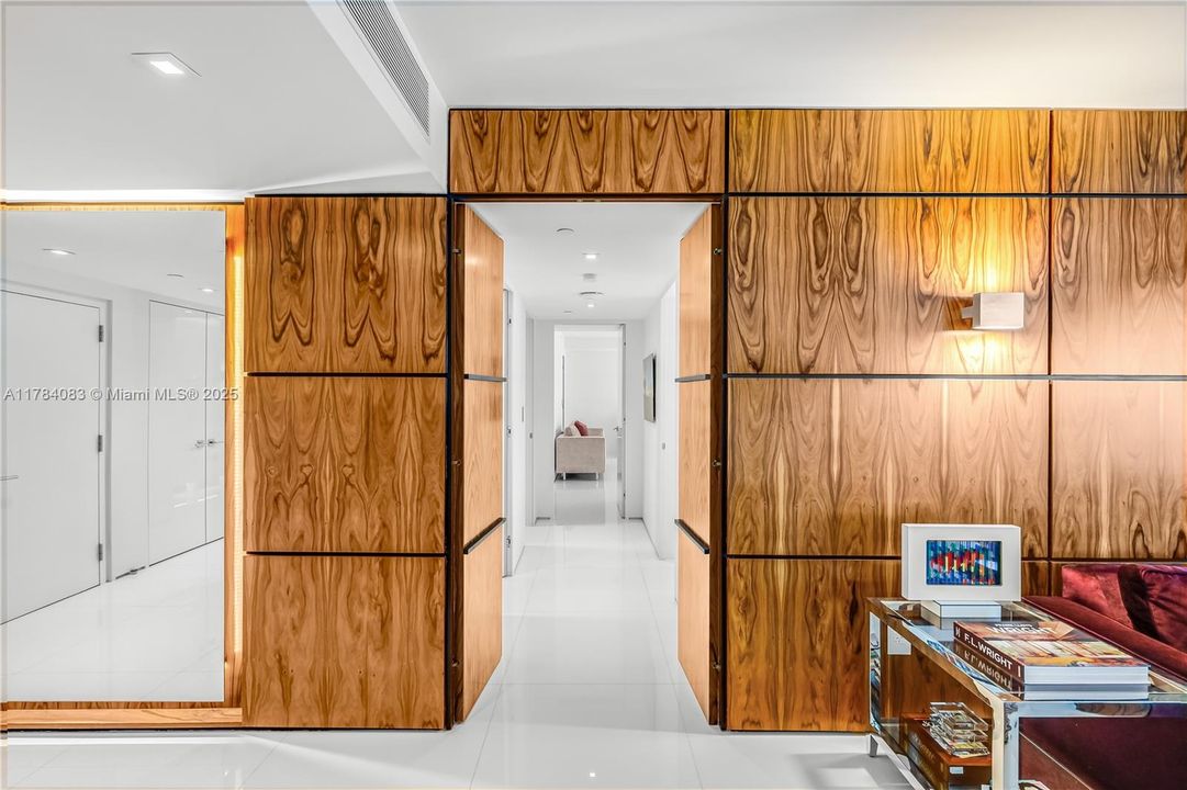 Meticulously designed  rosewood walls can close for privacy  or lead to the bedroom suites.