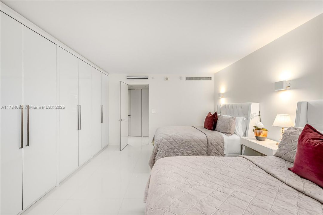 Huge guest bedroom, with custom built in closets.