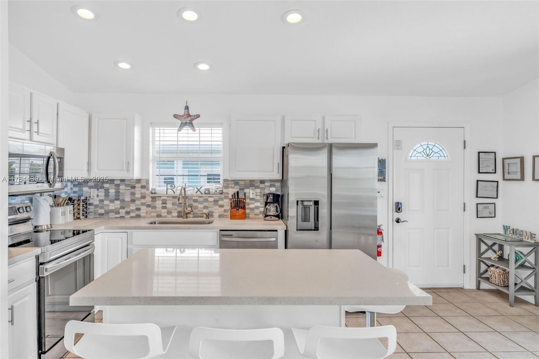 Open Layout Kitchen, Quartz Countertops, and Stainless Steel Appliances