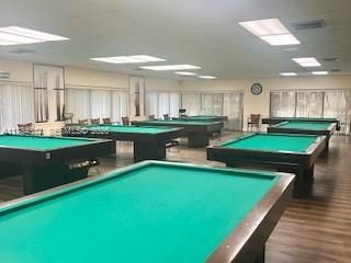 Expansive recreation room featuring wood-finish flooring and recessed ceiling lighting
