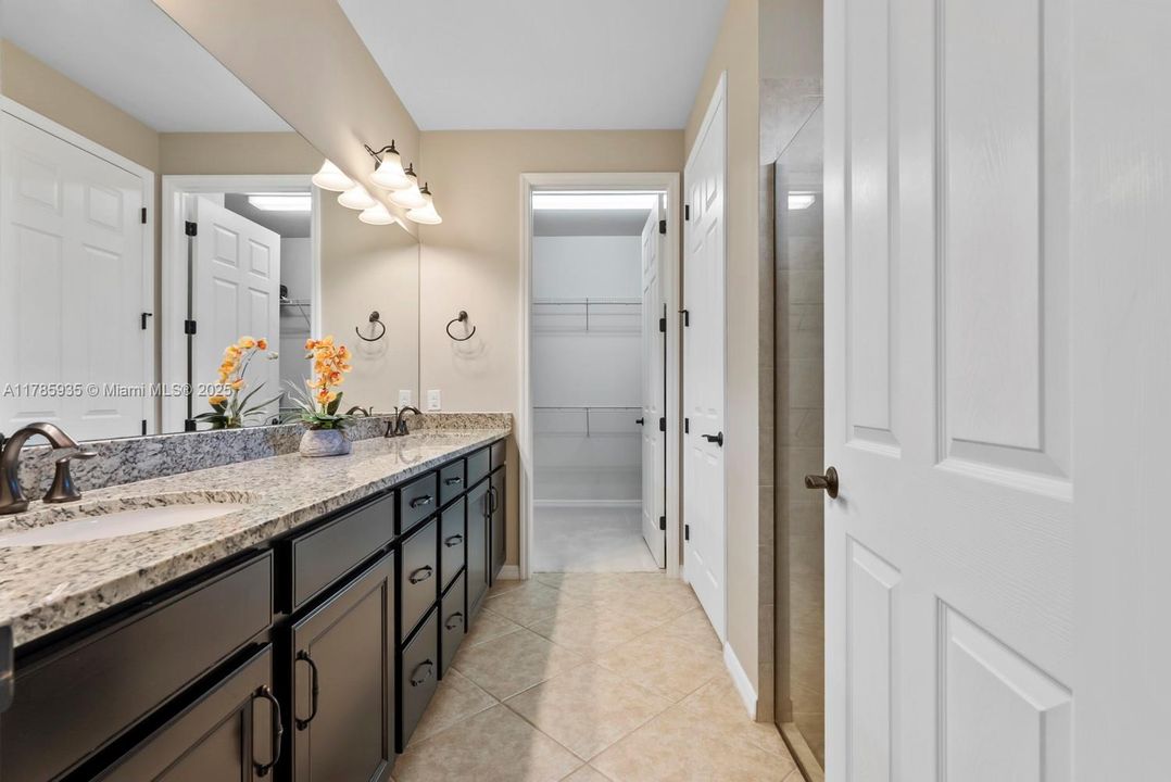 Primary Bathroom with raised dual vanity sinks