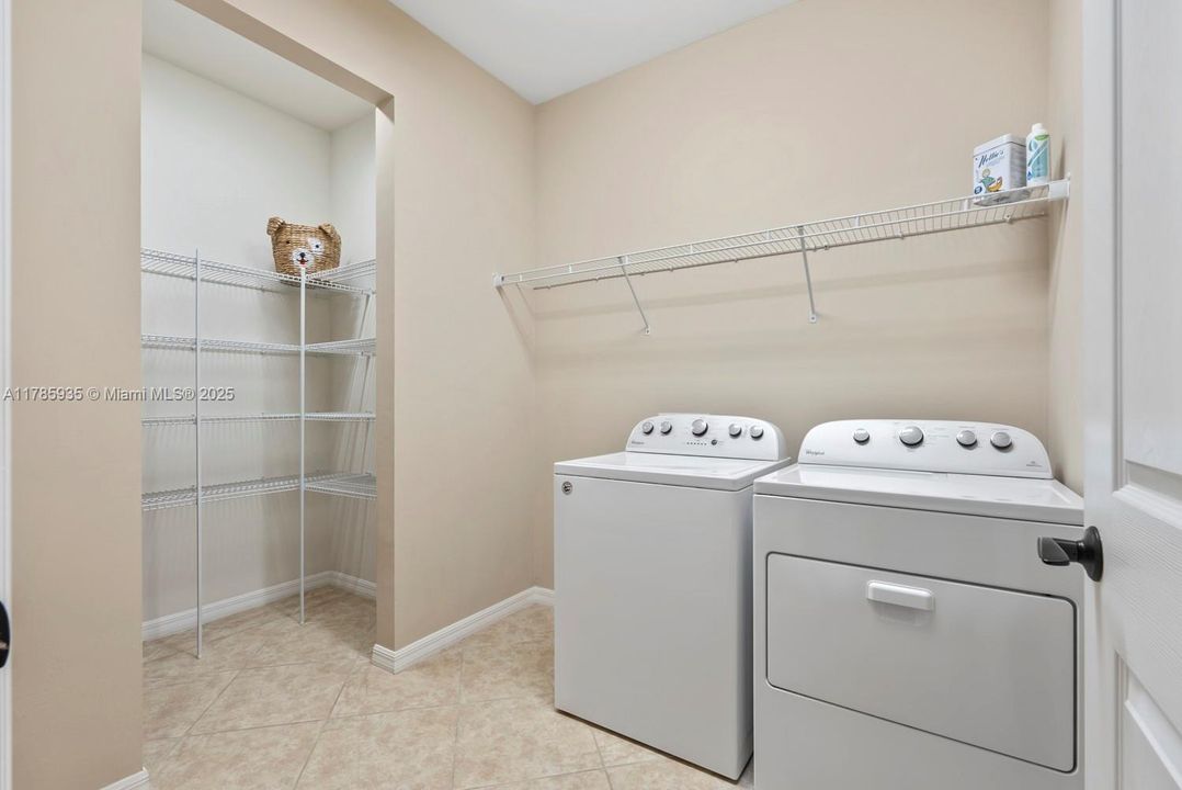 Laundry room with walk in storage or extra pantry