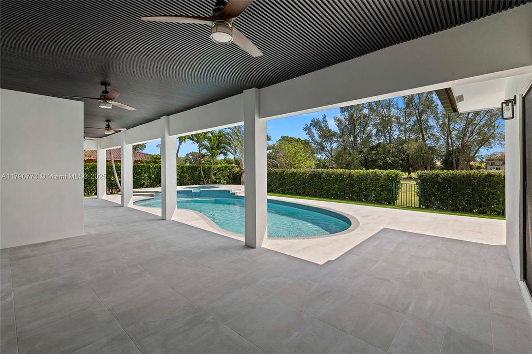 Expansive covered patio offers the perfect setting for poolside gatherings, al fresco dining, and relaxing afternoons.