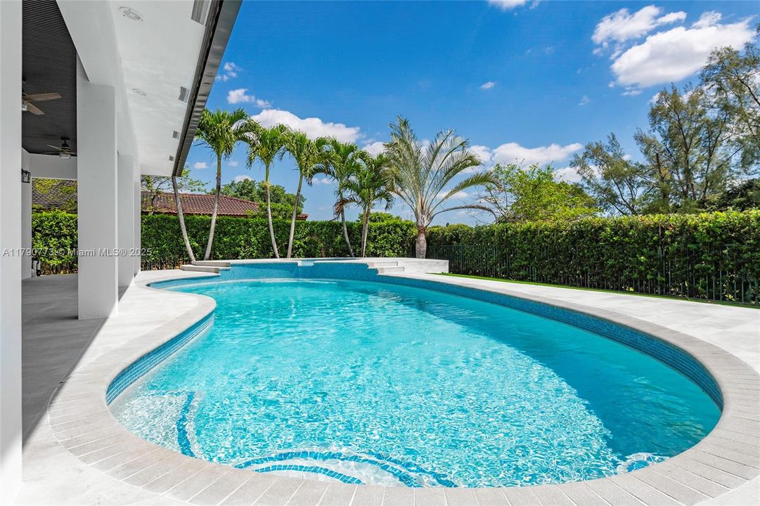 Experience the ultimate backyard  retreat with stunning free-form pool and heated sauna, all set against a lush privacy hedge that creates a serene, secluded oasis perfect for relaxation and entertaining.Experience the ultimate backyard retreat with a stunning free-form pool and heated sauna, all set against a lush privacy hedge that creates a serene, secluded oasis perfect for relaxation and entertaining.